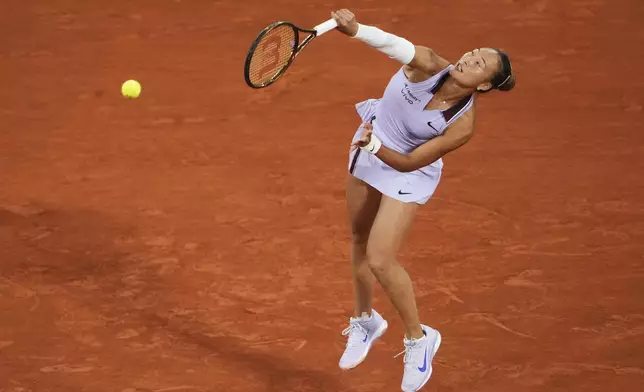 China's Zheng Qinwen serves against Russia's Anastasia Pavliuchenkova during their first round match of the French Tennis Open at the Roland Garros stadium, in Paris, Sunday May 25, 2025. (AP Photo/Lindsey Wasson)