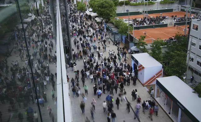 Fans walk by the courts on the occasion of the French Tennis Open, at the Roland-Garros stadium, in Paris, Wednesday, May 28, 2025. (AP Photo/Christophe Ena)