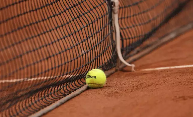 An official balll lies on the clay during a first round match of the French Tennis Open, at the Roland-Garros stadium, in Paris, Tuesday, May 27, 2025. (AP Photo/Aurelien Morissard)