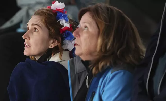 Fans watch the first round match of the French Tennis Open between France's Arthur Fils and Chile's Nicolas Jarry, at the Roland-Garros stadium, in Paris, Monday, May 26, 2025. (AP Photo/Lindsey Wasson)
