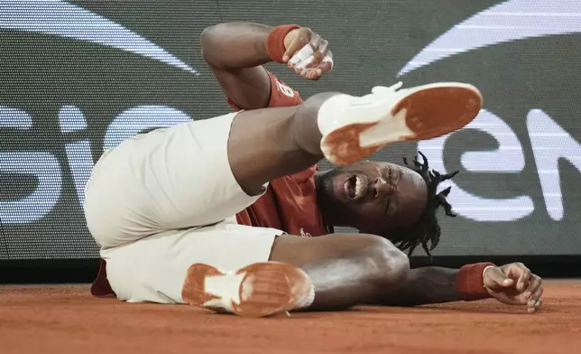 France's Gael Monfils falls as he plays against Bolivia's Hugo Dellien during their first round match of the French Tennis Open, at the Roland-Garros stadium, in Paris, Tuesday, May 27, 2025. (AP Photo/Christophe Ena)