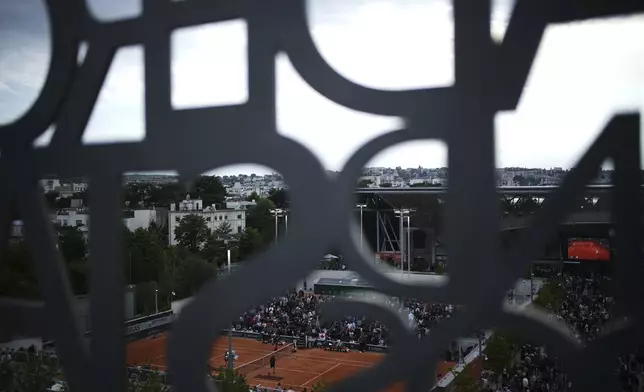 Fans watch matches of the French Tennis Open, at the Roland-Garros stadium, in Paris, Wednesday, May 28, 2025. (AP Photo/Christophe Ena)