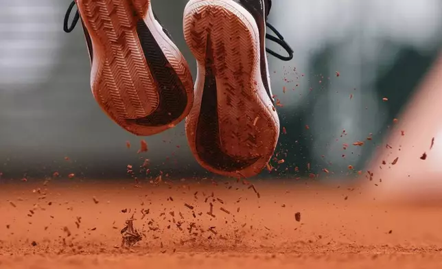 France's Terence Atmane kicks the clay as he serves against France's Richard Gasquet during their first round match of the French Tennis Open, at the Roland-Garros stadium, in Paris, Monday, May 26, 2025. (AP Photo/Lindsey Wasson)