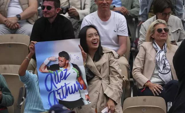 Fans cheer for France's Arthur Fils during his first round match of the French Tennis Open against Chile's Nicolas Jarry, at the Roland-Garros stadium, in Paris, Monday, May 26, 2025. (AP Photo/Lindsey Wasson)