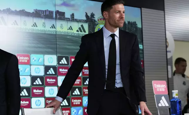 Former footballer Xavi Alonso arrives for a press conference during his presentation as Real Madrid's new coach at the Club's headquarters in Madrid on Monday 26 May 2025. (AP Photo/Jose Breton)