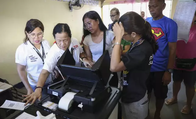 Voters cast their ballots at a polling station in Quezon City, Philippines, Monday, May 12, 2025. (AP Photo/Basilio Sepe)