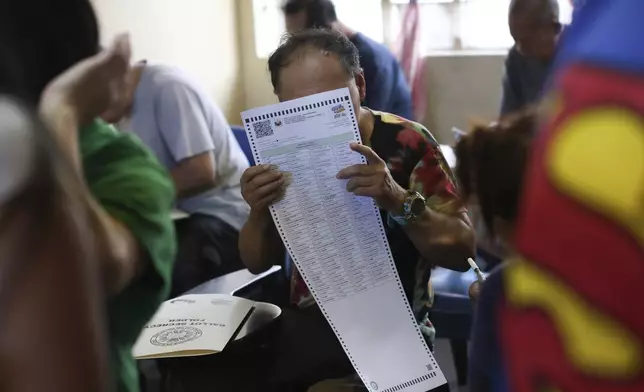 A man casts his ballot at a polling station in Quezon City, Philippines, Monday, May 12, 2025. (AP Photo/Basilio Sepe)