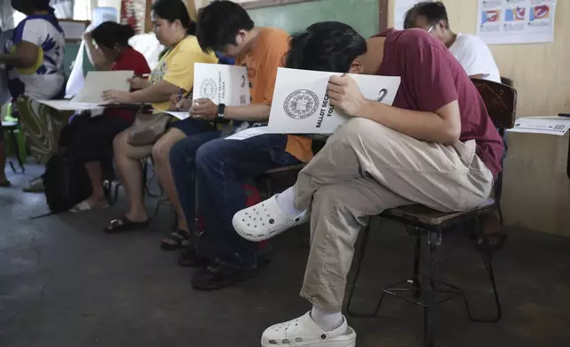 Voters cast their ballots at a polling station in Quezon City, Philippines, Monday, May 12, 2025. (AP Photo/Basilio Sepe)