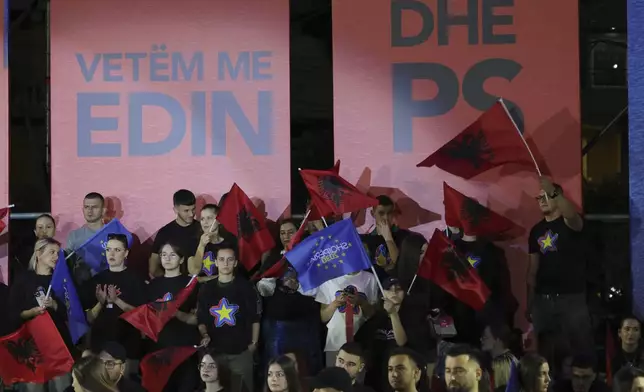 Supporters of Albania's Prime Minister Edi Rama wave flags of their country during his main election campaign rally in Tirana, Albania, Friday, May 9, 2025, as his ruling Socialist Party (PS) seeks a fourth term. (AP Photo/Vlasov Sulaj)