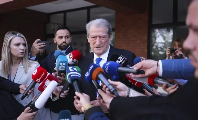 Sali Berisha, center, leader of Democratic Party of Albania, makes statements outside a voting station during a general election where rival Socialist Edi Rama is seeking a fourth term as Albania's prime minister in Tirana, Albania Sunday, May 11, 2025. (AP Photo)