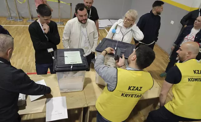 Ballot boxes are checked following the end of the voting procedure in Albania's parliamentary election after a boisterous campaign dominated by the country's uphill effort to join the European Union and Prime Minister Edi Rama's bid for a fourth term, in Tirana, Albania, Sunday, May 11, 2025. (AP Photo/Vlasov Sulaj)