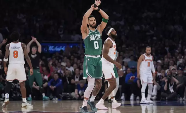 Boston Celtics' Jayson Tatum reacts after shooting a 3-point basket during the first half of Game 3 of an NBA basketball second-round playoff series against the New York Knicks, Saturday, May 10, 2025, in New York. (AP Photo/Pamela Smith)