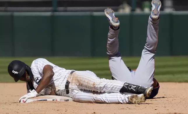 Chicago White Sox's Michael A. Taylor, left, is safe at second base with a double as Texas Rangers second baseman Marcus Semien, right, makes a late tag during the ninth inning of a baseball game Sunday, May 25, 2025, in Chicago. (AP Photo/David Banks)