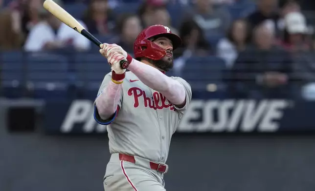 Philadelphia Phillies' Kyle Schwarber watches his home run in the second inning of a baseball game against the Cleveland Guardians in Cleveland, Sunday, May 11, 2025. (AP Photo/Sue Ogrocki)