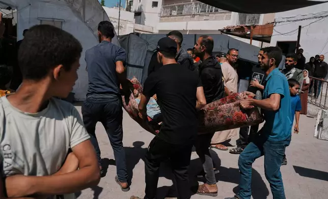 A Palestinian, who was injured in an Israeli airstrike, is brought for treatment at the Baptist Hospital in Gaza City, Friday, May 30, 2025. (AP Photo/Jehad Alshrafi)