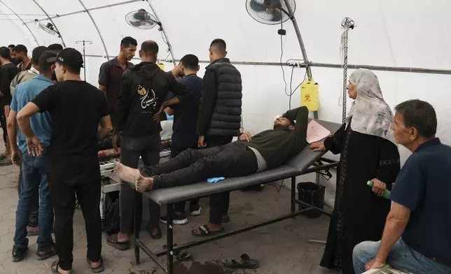 Palestinians lie on stretchers at the Baptist Hospital after being injured in an Israeli airstrike in Gaza City, Friday, May 30, 2025. (AP Photo/Jehad Alshrafi)