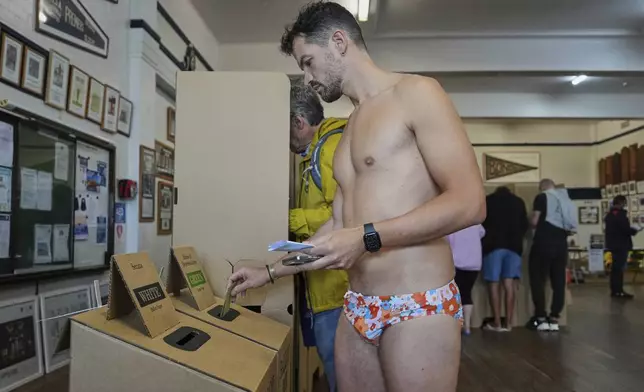 A man places his vote at a polling booth at Sydney's Bondi Beach, Saturday, May 3, 2025. (AP Photo/Mark Baker)