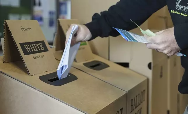 A man casts his vote at a polling booth at Sydney's Bondi Beach, Saturday, May 3, 2025. (AP Photo/Mark Baker)
