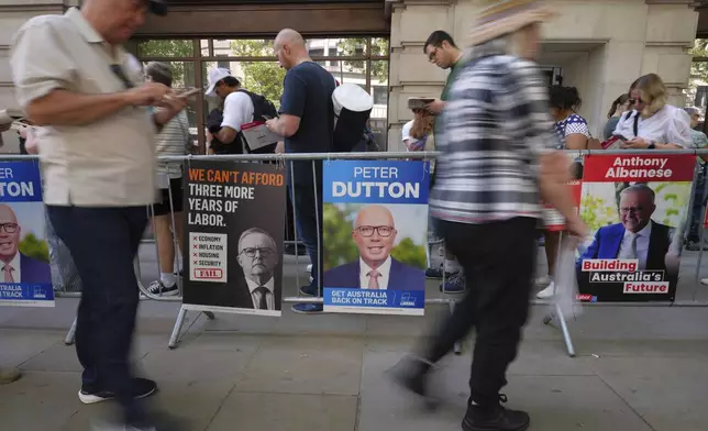 People queue outside the Australian High Commission in London to vote in the Australian federal election, Friday, May 2, 2025. (AP Photo/Kirsty Wigglesworth)