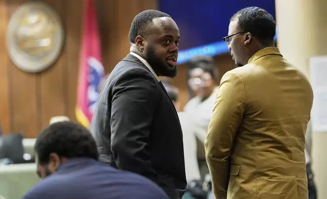 Former Memphis Police Officer Tedarrius Bean, center, one of three former Memphis officers charged with fatally beating Tyre Nichols in 2023, stands in the courtroom with his fellow defendants Justin Smith Jr., right, and Demetrius Haley, left, during break in the trial Wednesday, April 30, 2025, in Memphis, Tenn. (AP Photo/George Walker IV, Pool)