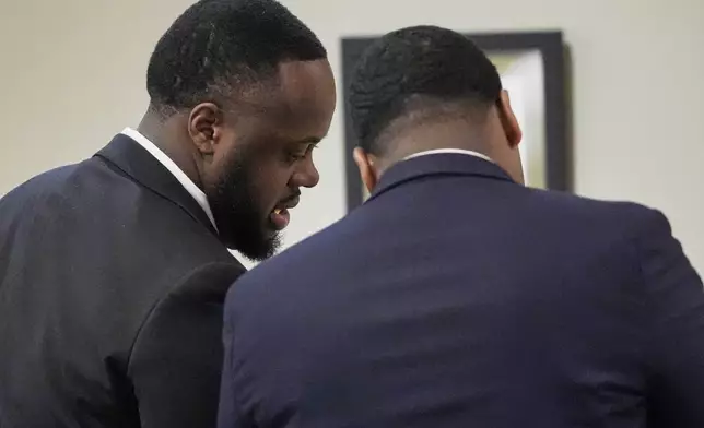 Former Memphis Police Officer Tedarrius Bean, left, one of three former Memphis officers charged with fatally beating Tyre Nichols in 2023, speaks to his attorney during his trial, Wednesday, April 30, 2025, in Memphis, Tenn. (AP Photo/George Walker IV, Pool)
