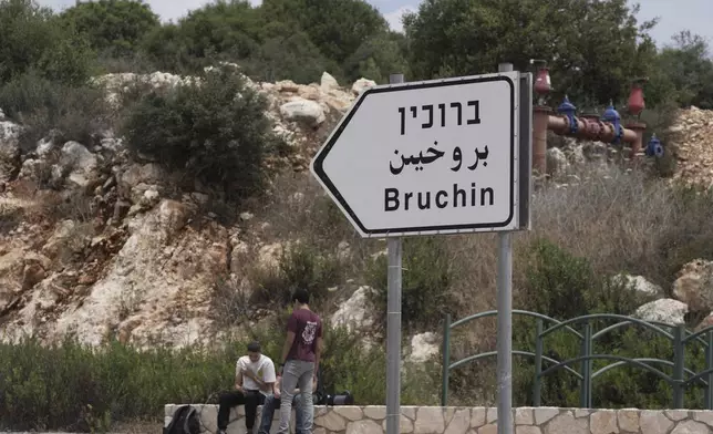 Young Israeli settlers sit outside of the West Bank settlement of Bruchin, the morning after a Palestinian gunman killed Tzeela Gez, who was on her way to the hospital to give birth, outside of the settlement, Thursday, May 15, 2025. (AP Photo/Maya Alleruzzo)