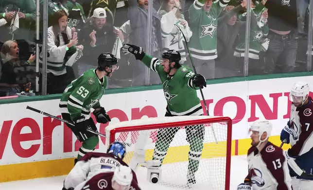 Dallas Stars' Wyatt Johnston (53) and Matt Duchene (95) celebrate after Johnston scored against the Colorado Avalanche in the third period in Game 7 of a first-round NHL hockey playoff series Saturday, May 3, 2025, in Dallas. (AP Photo/Julio Cortez)