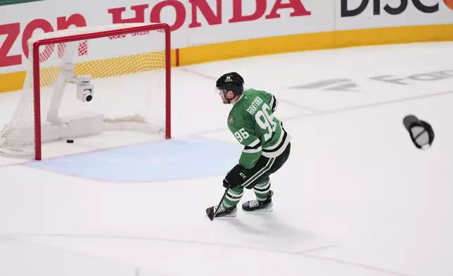 A hat is thrown onto the ice as Dallas Stars' Mikko Rantanen (96) scores an empty-net goal against to earn a hat trick in the third period in Game 7 of a first-round NHL hockey playoff series againts the Colorado Avalanche Saturday, May 3, 2025, in Dallas. (AP Photo/Julio Cortez)