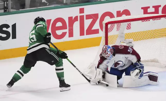 Colorado Avalanche goaltender Mackenzie Blackwood (39) blocks a shot by Dallas Stars' Thomas Harley (55) in the third period in Game 7 of a first-round NHL hockey playoff series Saturday, May 3, 2025, in Dallas. (AP Photo/Julio Cortez)