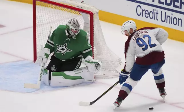 Colorado Avalanche's Gabriel Landeskog (92) loses control of the puck as he pressures Dallas Stars goaltender Jake Oettinger, left, in the third period in Game 7 of a first-round NHL hockey playoff series Saturday, May 3, 2025, in Dallas. (AP Photo/Julio Cortez)