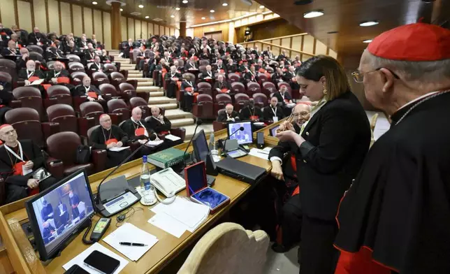 A Vatican employee annulls the papal seal on the pope's seal, at the Vatican, Tuesday, May 6, 2025. (Vatican Media via AP)