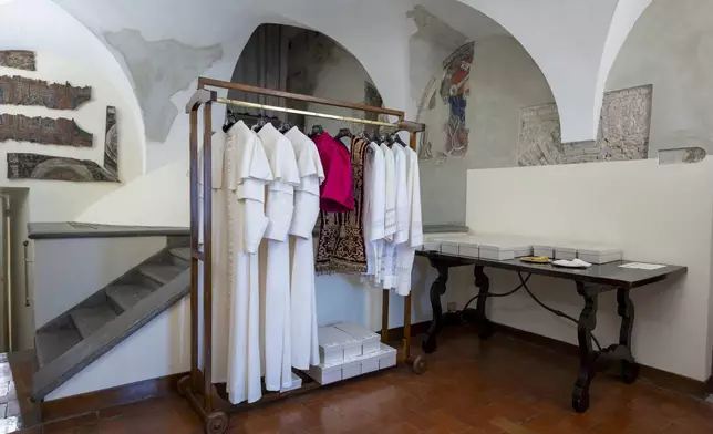 Papal vestments of three different sizes hang in the Room of the Tears, a chamber next to the Sistine Chapel where the new pope dresses before appearing on the balcony, at the Vatican, Tuesday, May 6, 2025. (Vatican Media via AP)