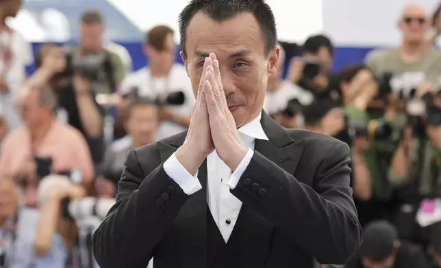 Yongzhong Chen poses for photographers at the photo call for the film "Resurrection" at the 78th international film festival in Cannes, southern France, Friday, May 23, 2025. (AP Photo/Natacha Pisarenko)