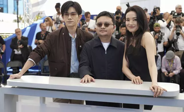 Jackson Yee, from left, director Bi Gan and Shu Qi pose for photographers at the photo call for the film "Resurrection" at the 78th international film festival in Cannes, southern France, Friday, May 23, 2025. (AP Photo/Natacha Pisarenko)