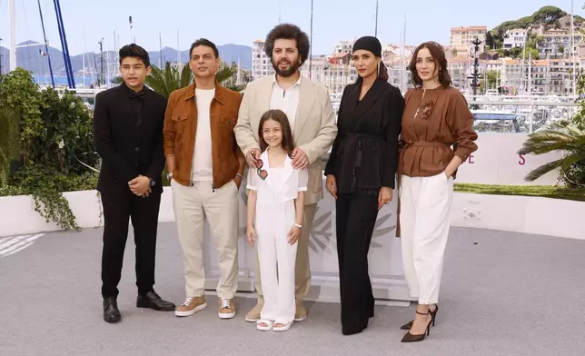 Sinan Mohebi, from back left, Payman Maadi, director Saeed Roustayi, Parinaz Izadyar, Soha Niasti and Arshida Dorostkar, front, pose for photographers at the photo call for the film 'Woman and Child' at the 78th international film festival, Cannes, southern France, Friday, May 23, 2025. (Photo by Joel C Ryan/Invision/AP)