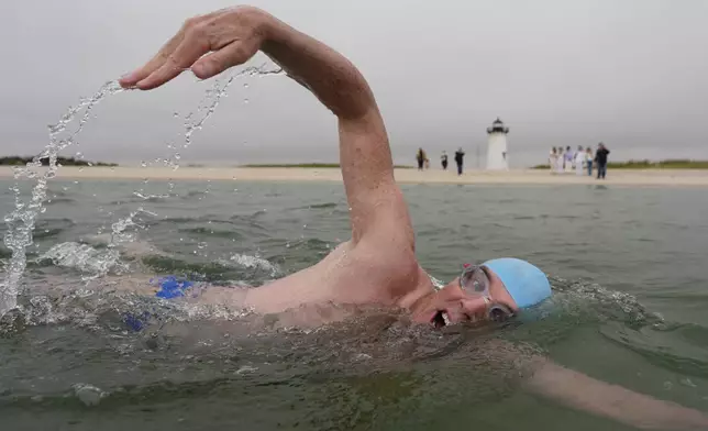 Endurance swimmer Louis Pugh swims near the Edgartown Harbor Light, Thursday, May 15, 2025, in Edgartown, Mass. (AP Photo/Robert F. Bukaty)