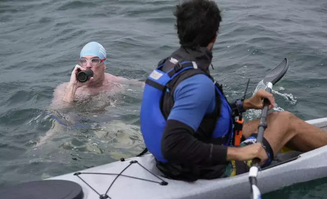 Endurance swimmer Louis Pugh pauses to rehydrate during the first day of his swim around Martha's Vineyard, Thursday, May 15, 2025, off Edgartown, Mass. (AP Photo/Robert F. Bukaty)