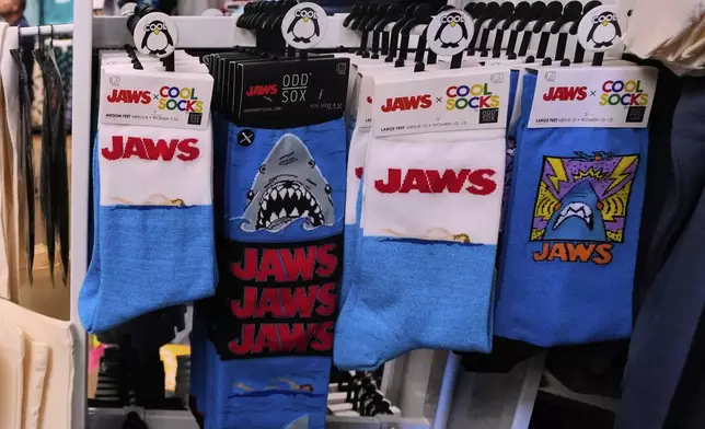 Socks featuring the Jaws movie are displayed at Neptune's Sea Chest gift shop, Monday, May 12, 2025, in Vineyard Haven, Mass., on Martha's Vineyard Island. (AP Photo/Charles Krupa)