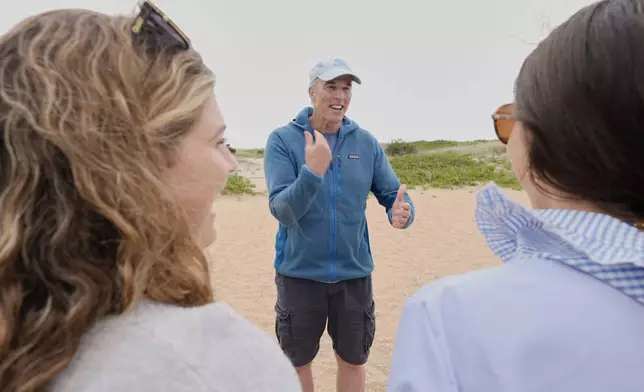 Endurance swimmer Louis Pugh chats with visitors to Martha's Vineyard, Thursday, May 15, 2025, in Edgartown, Mass. (AP Photo/Robert F. Bukaty)