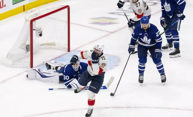 Florida Panthers center Anton Lundell (15) celebrates after scoring against Toronto Maple Leafs goaltender Joseph Woll (60) during the second period of Game 7 of a second-round NHL hockey playoff series in Toronto, Sunday, May 18, 2025. (Chris Young/The Canadian Press via AP)