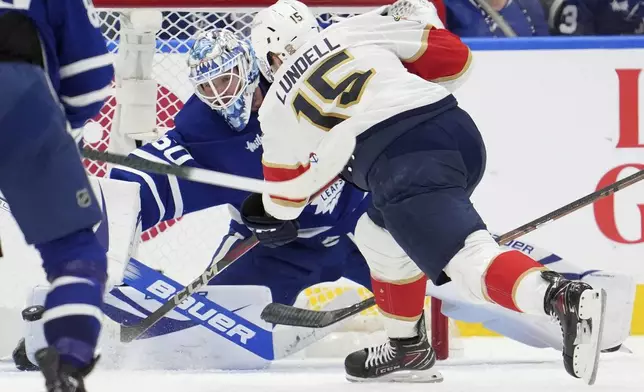 Florida Panthers centerAnton Lundell (15) scores against Toronto Maple Leafs goaltender Joseph Woll (60) during the second period of Game 7 of a second-round NHL hockey playoff series in Toronto, Sunday, May 18, 2025. (Frank Gunn/The Canadian Press via AP)