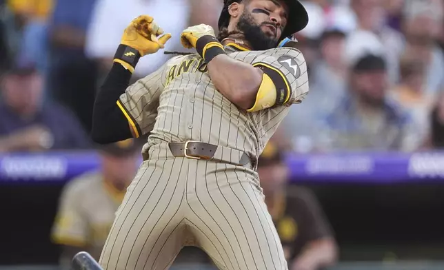 San Diego Padres' Fernando Tatis Jr. reacts to a high inside pitch by Colorado Rockies reliever Juan Mejia in the fourth inning of a baseball game Saturday, May 10, 2025, in Denver. (AP Photo/David Zalubowski)