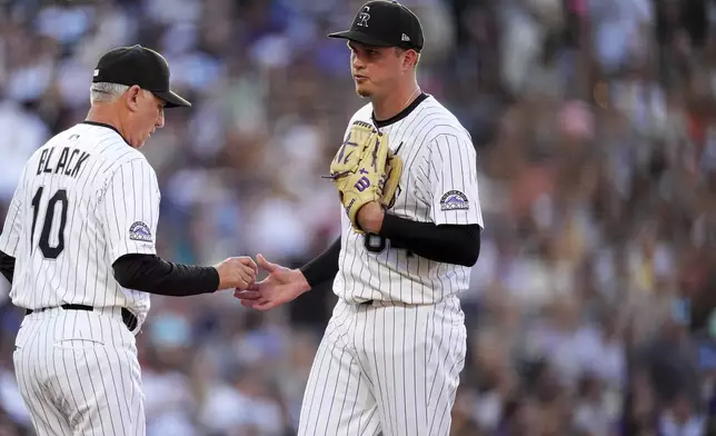 Colorado Rockies manager Bud Black, left, takes the ball from starting pitcher Bradley Blalock, right, who is pulled from the mound after giving up a two-run home run to San Diego Padres' Jason Heyward in the fourth inning of a baseball game Saturday, May 10, 2025, in Denver. (AP Photo/David Zalubowski)