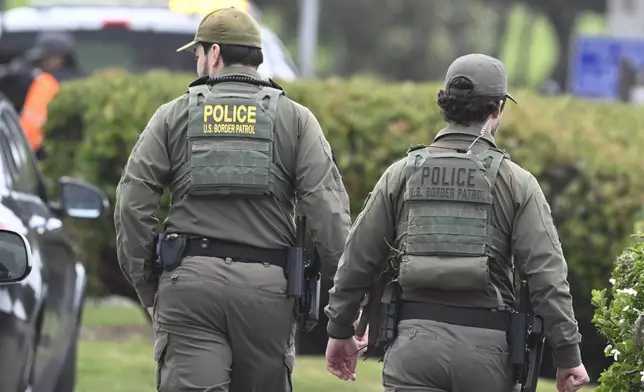 U.S. Border Patrol agents search Seagrove Park in Del Mar after a boat capsized Monday, May 5, 2025, at Torrey Pines State beach in San Diego, Calif. (AP Photo/Denis Poroy)