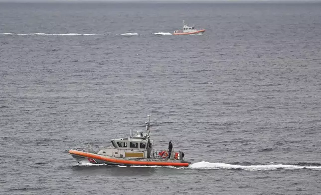 U.S Coast Guard boats look for survivors after a boat capsized in the surf Monday, May 5, 2025, at Torrey Pines State beach in San Diego, Calif. (AP Photo/Denis Poroy)