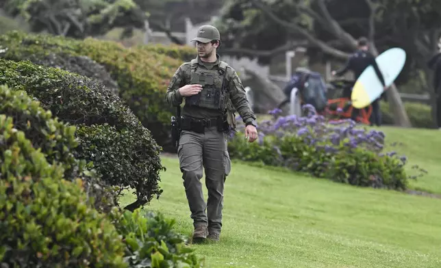 A U.S. Border Patrol agent searches Seagrove Park in Del Mar after a boat capsized Monday, May 5, 2025, at Torrey Pines State beach in San Diego, Calif. (AP Photo/Denis Poroy)