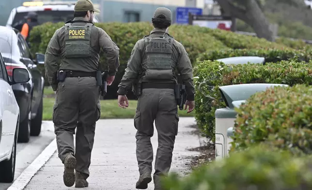 U.S. Border Patrol agents search Seagrove Park in Del Mar after a boat capsized Monday, May 5, 2025, at Torrey Pines State beach in San Diego, Calif. (AP Photo/Denis Poroy)