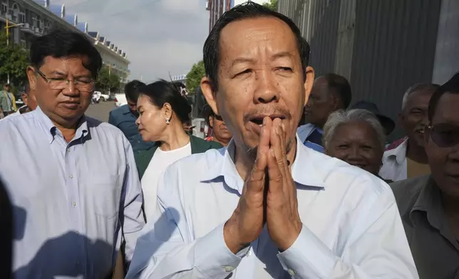 Cambodian prominent opposition politician Rong Chhun greets his supporters near the Phnom Penh Municipal Court in Phnom Penh, Cambodia, Monday, May 5, 2025. (AP Photo/Heng Sinith)
