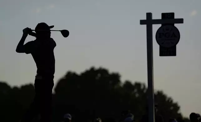 Rickie Fowler watches his tee shot on the 10th hole during the first round of the PGA Championship golf tournament at the Quail Hollow Club, Thursday, May 15, 2025, in Charlotte, N.C. (AP Photo/David J. Phillip)