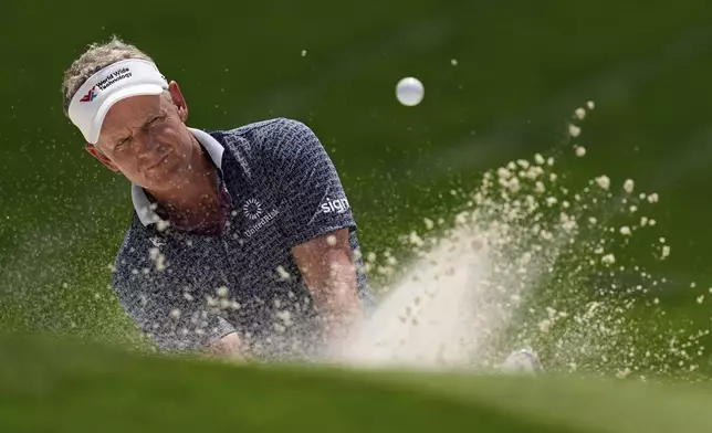 Luke Donald, of England, hits from the bunker on the 18th hole during the first round of the PGA Championship golf tournament at the Quail Hollow Club, Thursday, May 15, 2025, in Charlotte, N.C. (AP Photo/David J. Phillip)